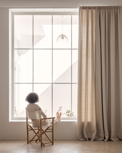 window with heavy linen curtain by Equipo DRT