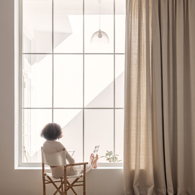 window with heavy linen curtain by Equipo DRT