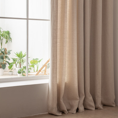 Natural linen curtain filtering sunlight in a minimalist living room